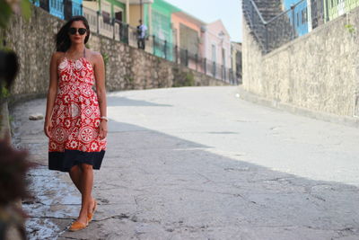 Full length of young woman standing in city