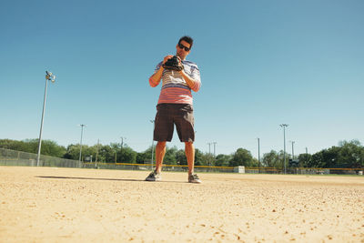 Full length of man running against clear sky