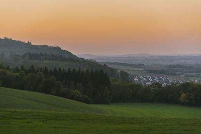 Scenic view of landscape against sky during sunset