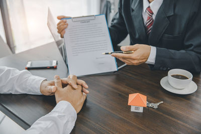 Midsection of business colleagues working at table