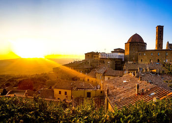 Buildings in city at sunset