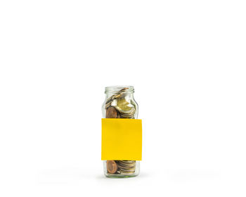 Close-up of glass of jar against white background