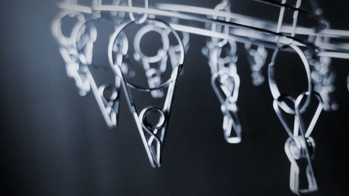 Close-up of love hanging on metal against black background