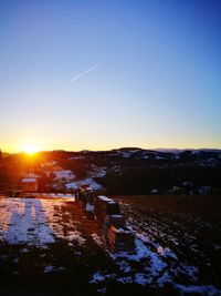 Scenic view of landscape against clear sky during sunset