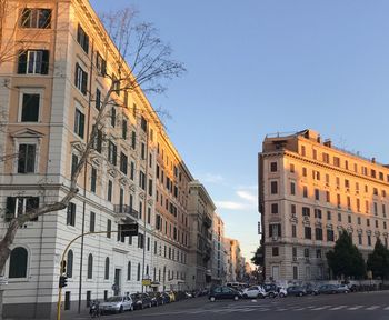 City street and buildings against sky