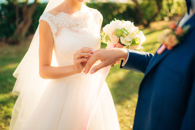 Midsection of woman holding bouquet