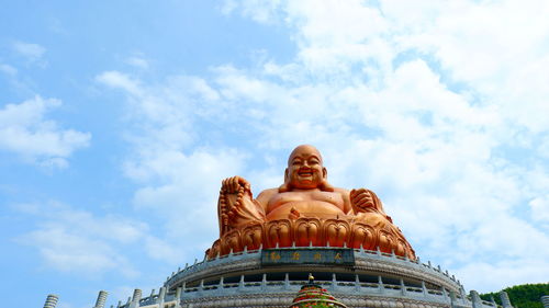 Low angle view of statue against temple against sky