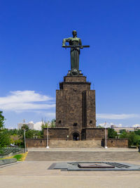 Low angle view of statue against clear blue sky