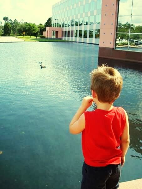 BOY STANDING BY SEA