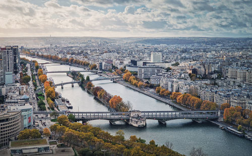 Aerial panorama of paris city, france. multiple bridges over the seine river and vibrant colored