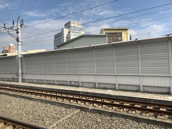 Train at railroad station against sky