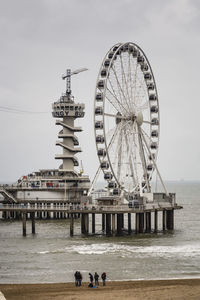 People on pier at sea