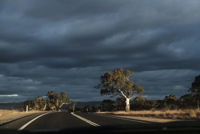 Car on road against dramatic sky