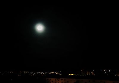 Illuminated moon against sky at night