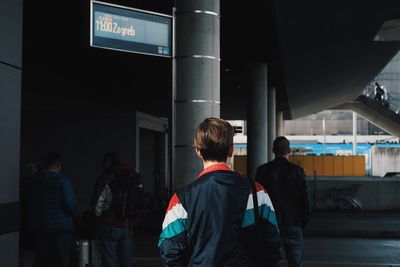 Rear view of young man at transportation building