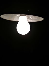 Low angle view of illuminated lamp in dark