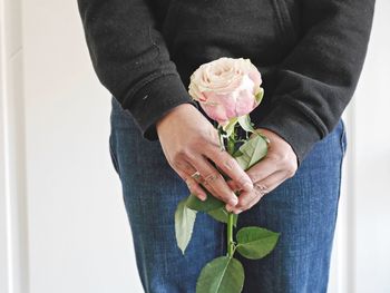 Close-up of hands holding rose
