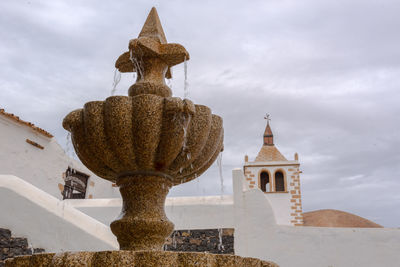 Low angle view of statue of building against sky