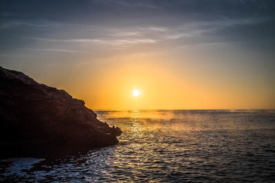 Scenic view of sea against sky at sunset