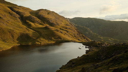 Scenic view of lake and mountains against sky