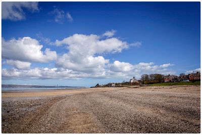 Scenic view of landscape against blue sky