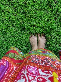 Low section of woman on field