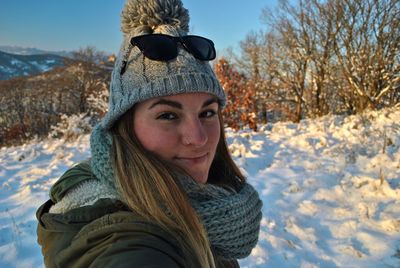 Portrait of young woman wearing warm clothing in winter