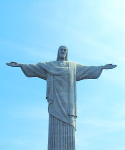 Low angle view of statue against blue sky