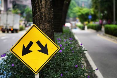 Close-up of arrow sign on road