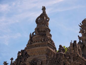 Low angle view of statue of temple against sky