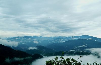 Scenic view of mountains against cloudy sky