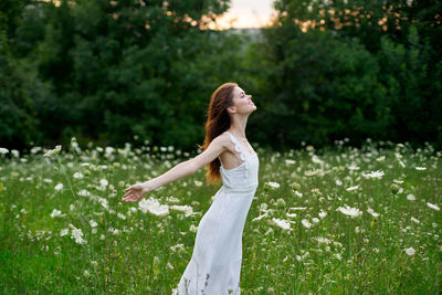 Side view of woman standing on field