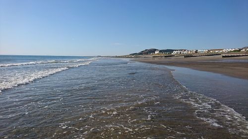 Scenic view of beach against clear sky