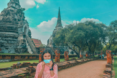 Portrait of mature man outside temple against building