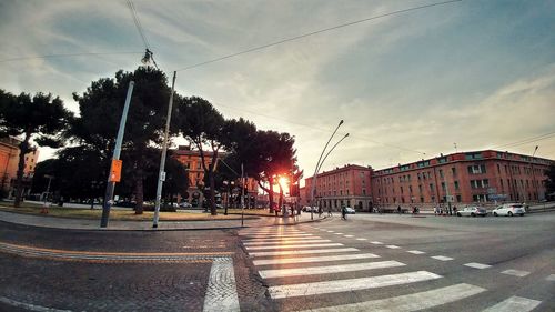 View of city street against cloudy sky