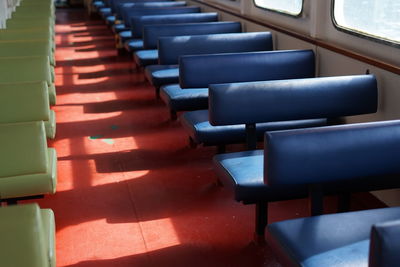 Empty chairs and tables in row