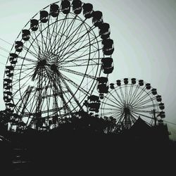 Low angle view of ferris wheel against sky