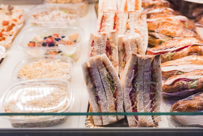 Several croissant stuffed with tuna lettuce and tomato on display for sale