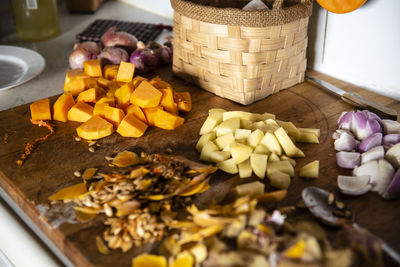 Woman cooking a vegetable soup with pumpkin, potato and onion.