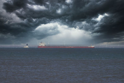 Scenic view of sea against storm clouds