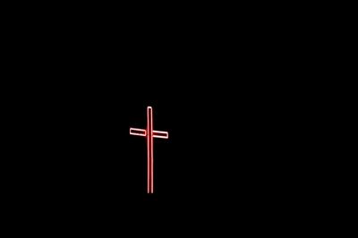 Close-up of cross against black background