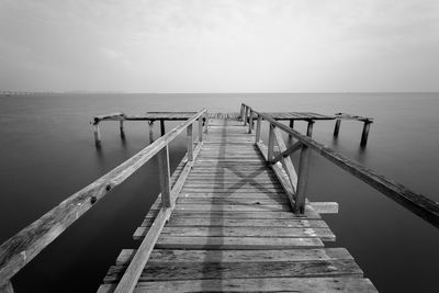 Pier over sea against sky