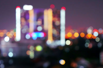 Defocused image of illuminated city at night