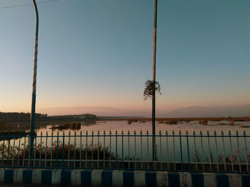 Scenic view of lake against clear sky during sunset