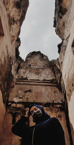 Low angle view of man standing against sky