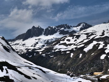 Scenic view of snow covered mountains against sky