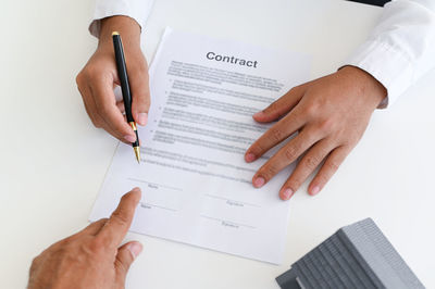 Cropped hands of man working on table