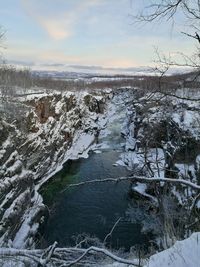 Scenic view of frozen lake against sky during winter