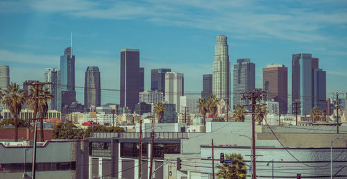 Modern buildings in city against sky