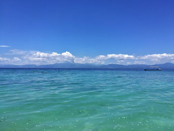 Scenic view of sea against blue sky